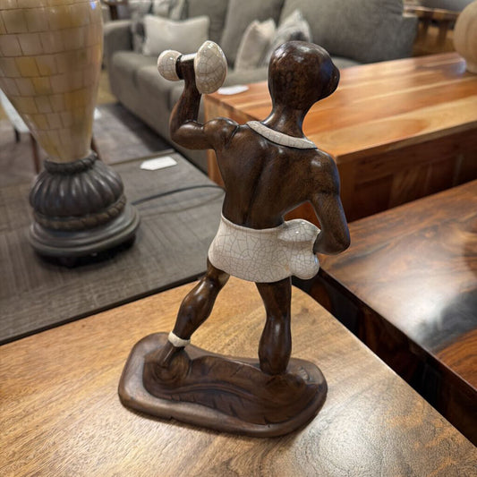 Wooden sculpture of a boxer on a wooden table