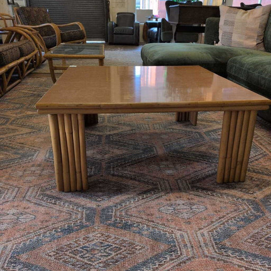 Wooden coffee table in a living room setting with furniture and decor.