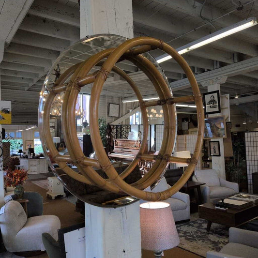 Large wooden circular sculpture in a room with furniture and decor