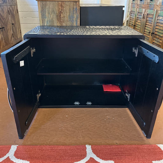 Black metal safe with open door on a wooden floor
