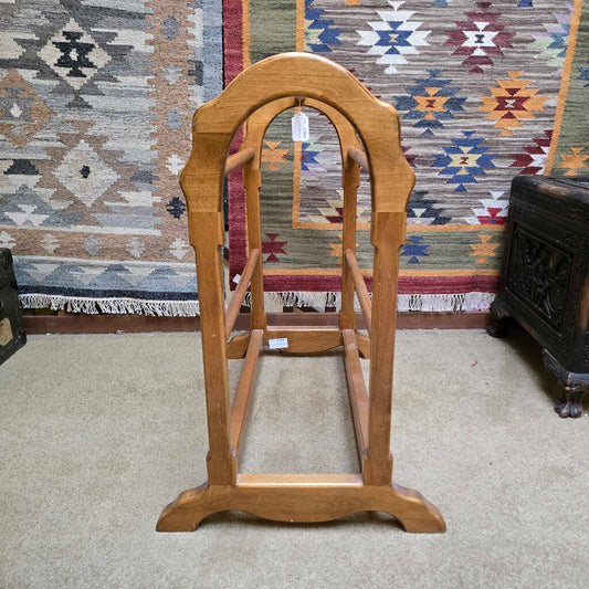 Wooden stand with a mirror against a patterned rug background