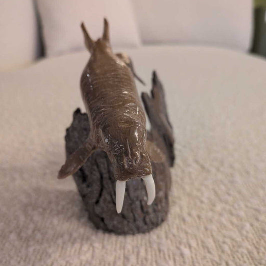 Toy alligator with a wrapped body on a textured surface