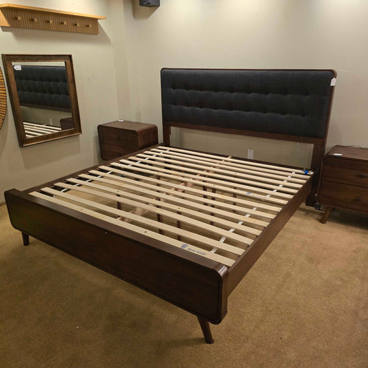 Wooden bed frame with slats in a room setting