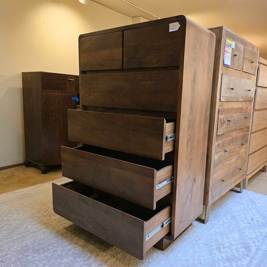 Wooden furniture with multiple drawers on a light-colored floor.