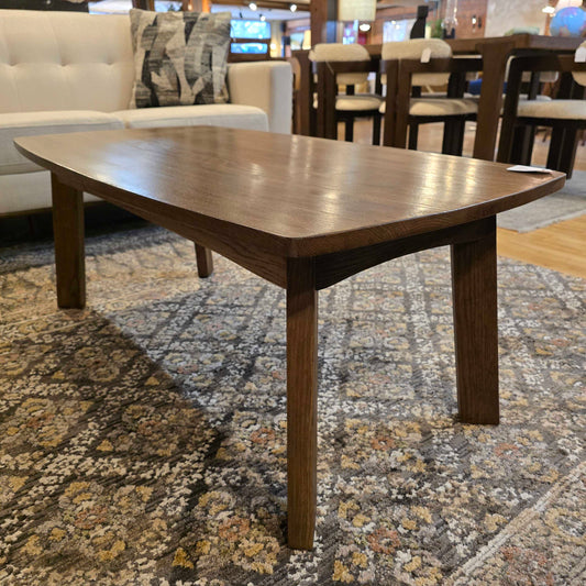 Wooden dining table with a patterned rug underneath