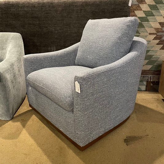 Gray armchair with a tag in a store setting
