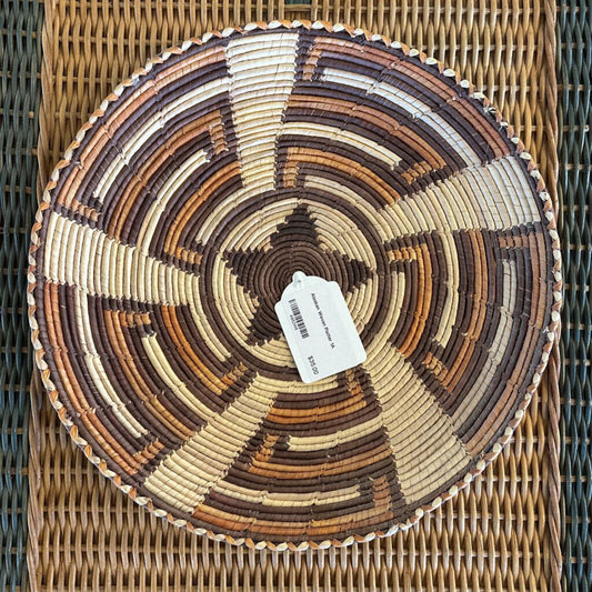 Woven basket with a concentric circle pattern on a woven surface