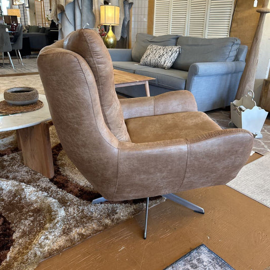 Brown armchair in a room with a gray sofa and wooden coffee table.