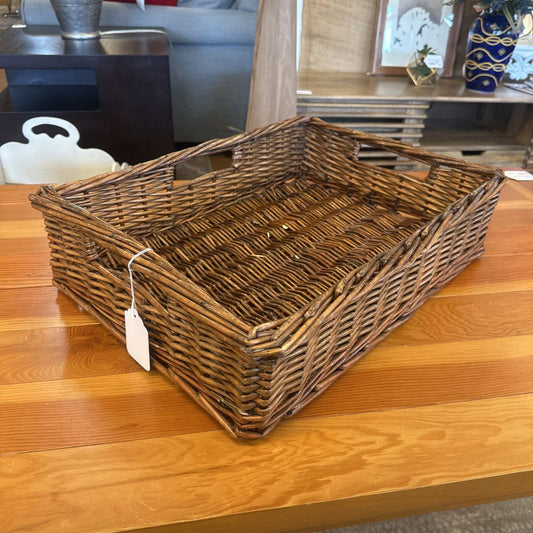 Wicker basket on a wooden table with a tag