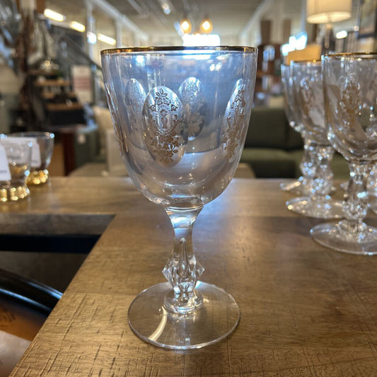 Decorative glass goblet on a wooden surface with blurred background