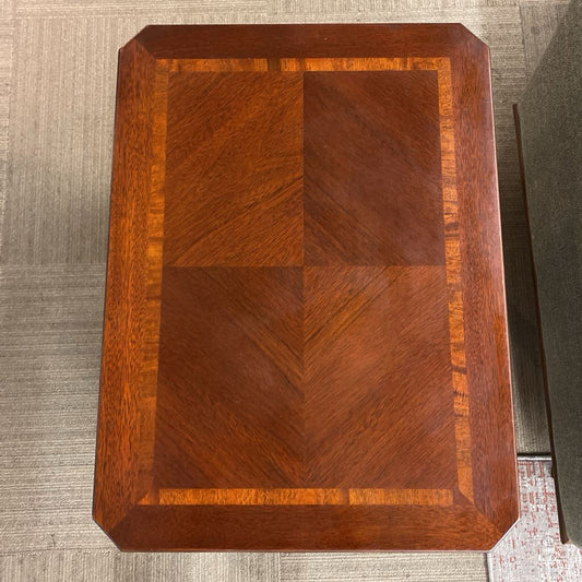 Wooden cutting board with a checkered pattern on a textured surface