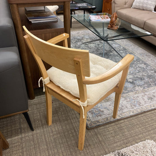 Wooden chair with a cushion in a living room setting