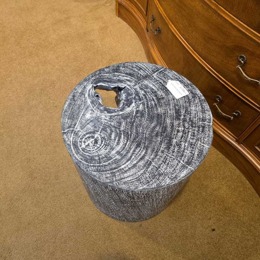Wooden stool with a rustic design on a carpeted floor next to a wooden cabinet.