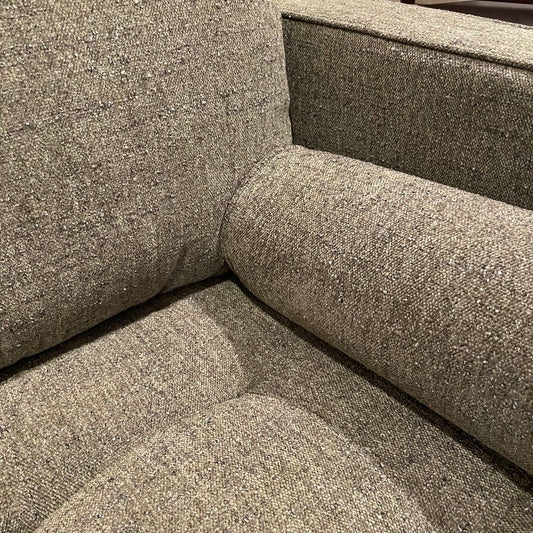 Textured gray fabric on a sofa corner