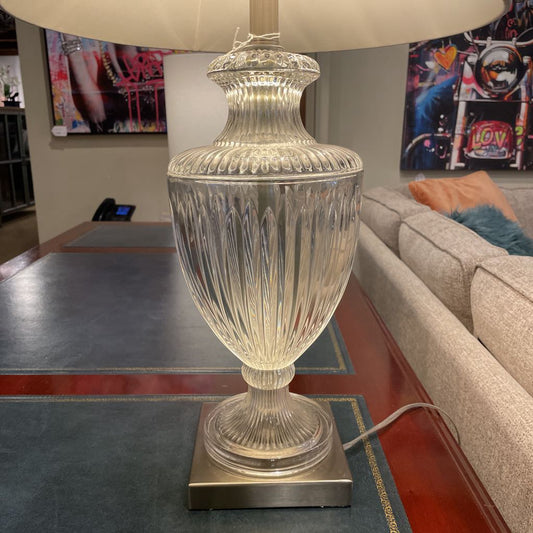 Decorative table lamp with a glass base in a living room setting