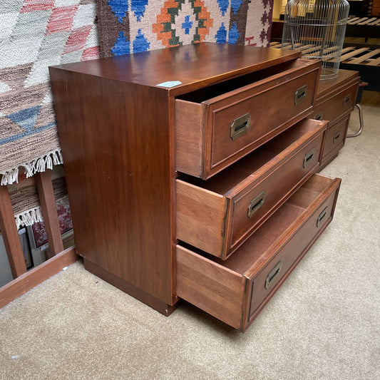 Wooden dresser with multiple drawers in a store setting