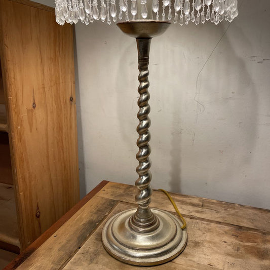 Vintage-style lamp with twisted metal base on a wooden surface