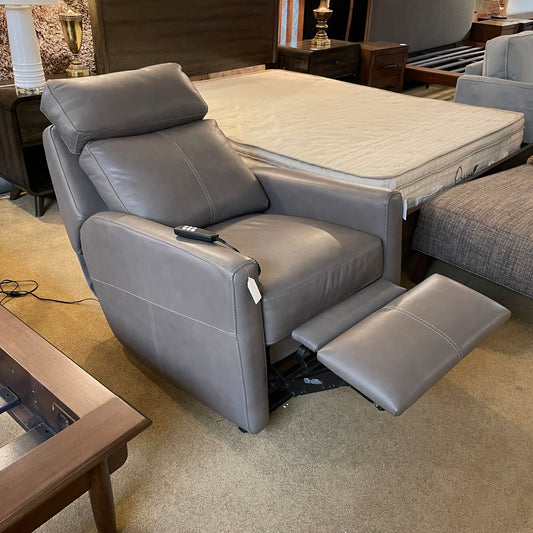 Gray recliner chair with footrest in a room setting