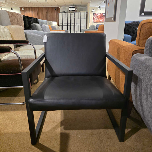 Black bar stool with metal legs in a showroom setting