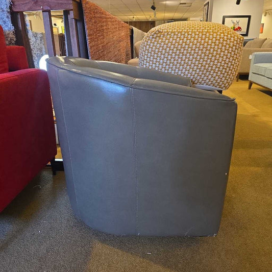 Gray chair in a room with other chairs and furniture