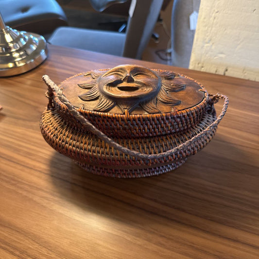 Woven basket with lid on a wooden surface