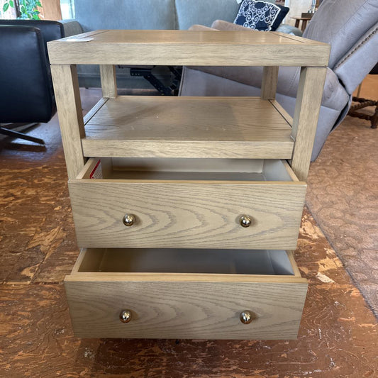 Wooden side table with two drawers in a living room setting