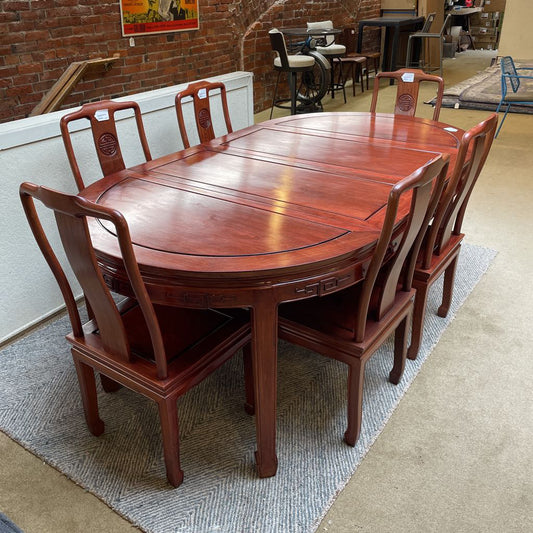 Wooden dining table with chairs in a showroom setting