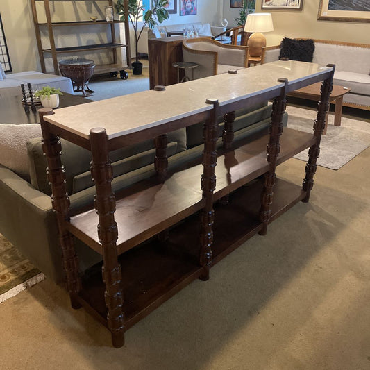 Wooden console table with marble top in a living room setting