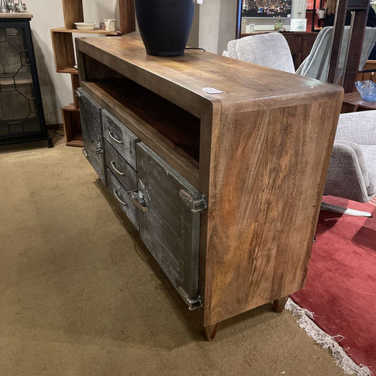Wooden console table with metal accents in a room setting