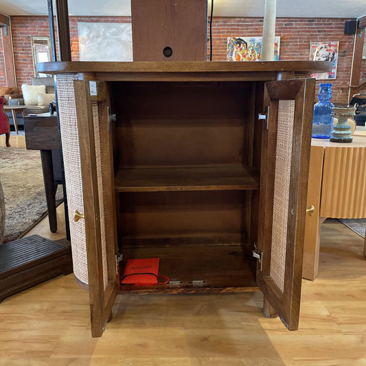 Wooden cabinet with open doors on a wooden floor