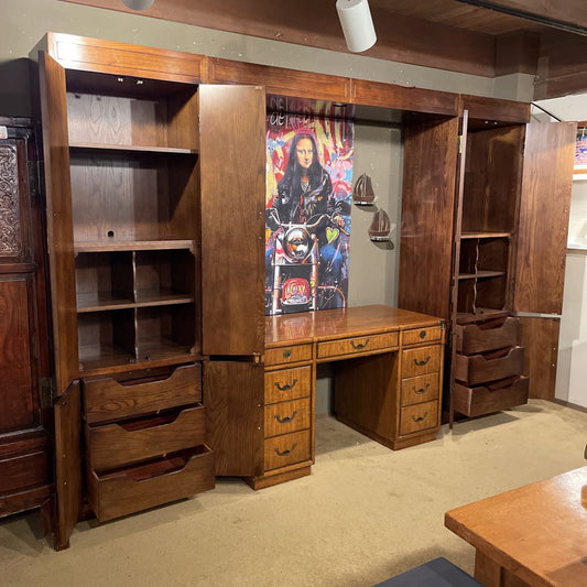 Wooden wardrobe with a desk and shelves in a room setting