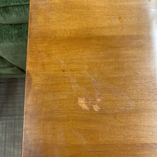 Close-up of a wooden surface with visible grain and a small scratch.