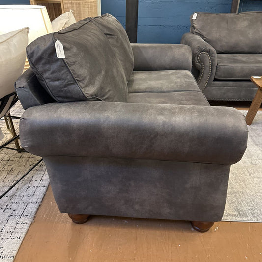 Gray sofa with a tag in a store setting