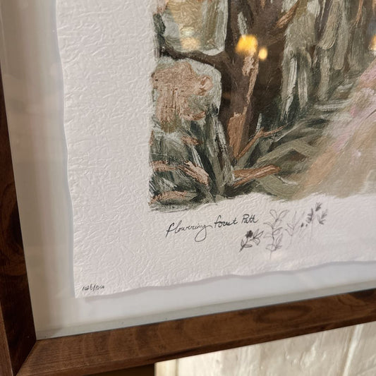 Framed artwork of a nature scene with a signature on textured paper.