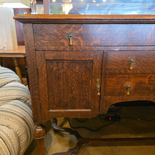 Wooden cabinet with brass handles in a room setting