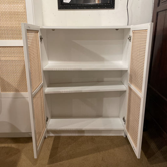 White cabinet with wicker doors in a room setting