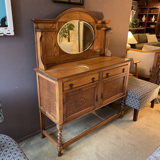 Wooden sideboard with mirror in a room setting