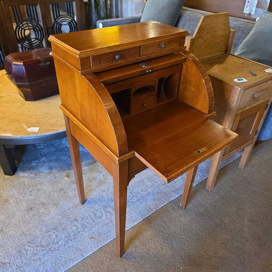 Wooden desk with a curved front in an indoor setting