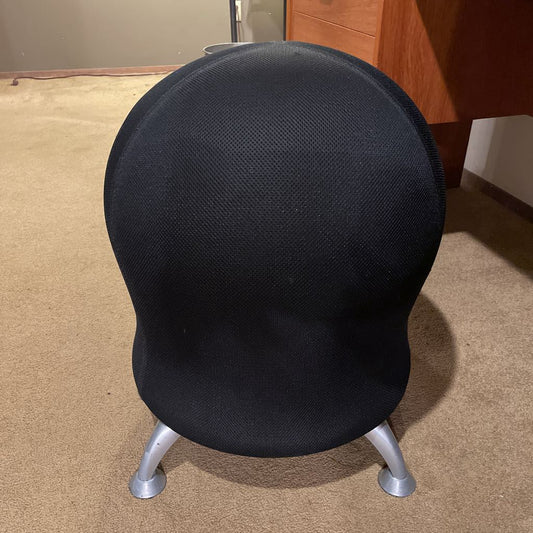 Black office chair with silver base on a carpeted floor.