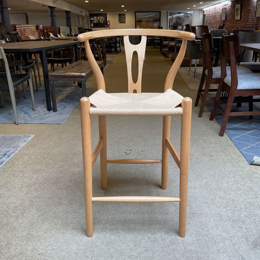 Wooden chair with woven seat in a room with tables and chairs