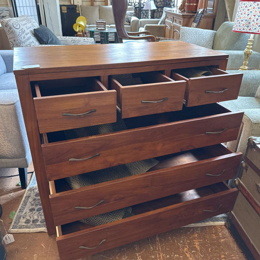 Wooden dresser with multiple drawers in a living room setting