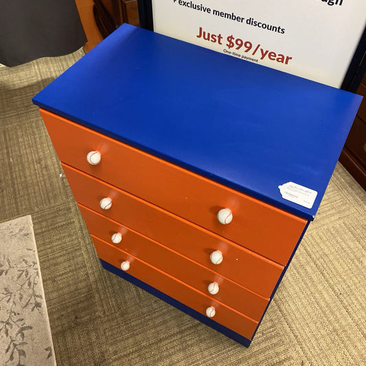 Blue and orange dresser with white knobs on a carpeted floor.