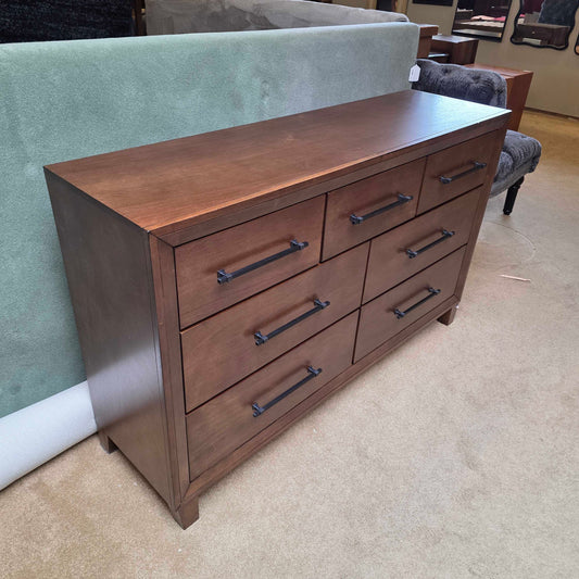 Wooden dresser with multiple drawers in a room setting