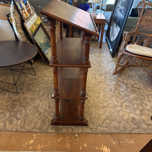 Wooden three-tiered stand in a room with furniture and decor
