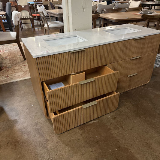 Bathroom vanity with marble countertop in a showroom setting