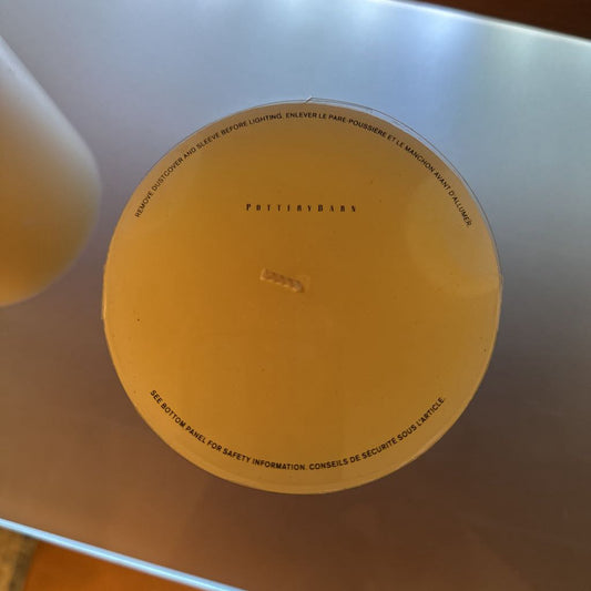 Round orange object with text on a reflective surface
