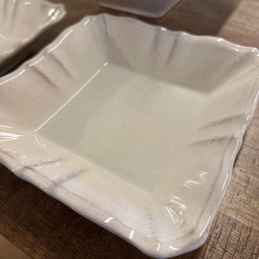 White ceramic square bowl on a wooden surface