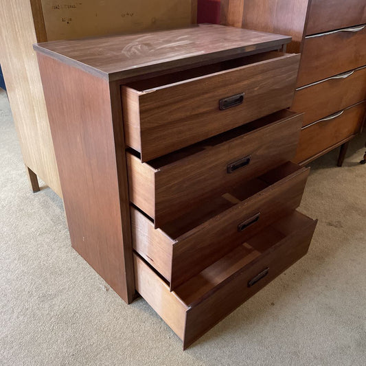 Wooden dresser with multiple drawers on a carpeted floor