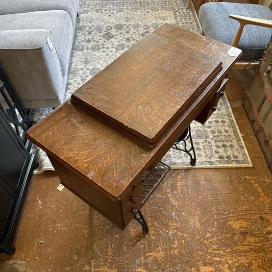 Wooden desk with a vintage design in a room with furniture and a rug.