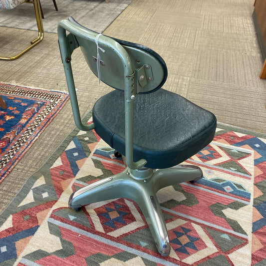 Vintage-style chair on a patterned rug with a carpeted floor in the background